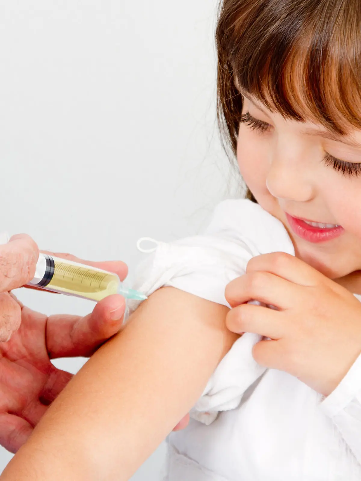 Girl getting a vaccine at the hospital