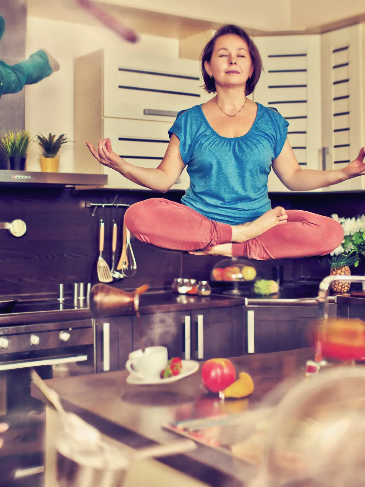Mother meditating at the kitchen with her children flying around