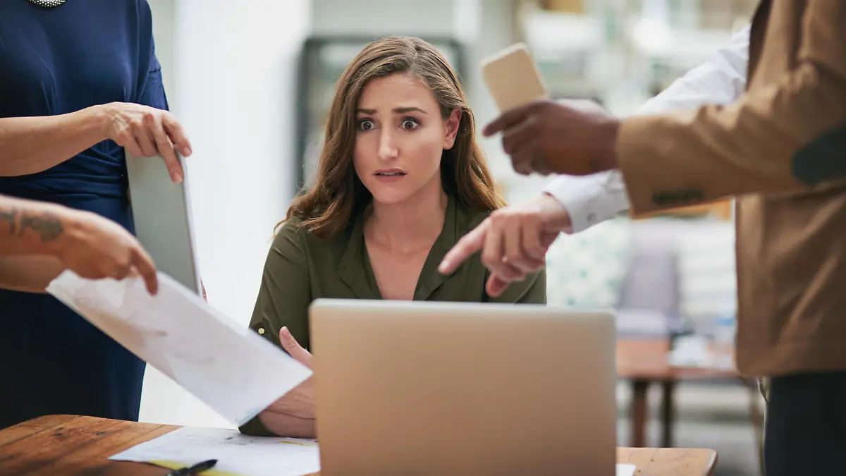 Shot of a young businesswoman looking anxious in a demanding office environment