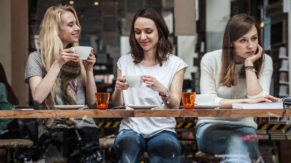 Group of women seated at a cafe's window relaxing during a cold afternoon in Scandinavia, Copenhagen.