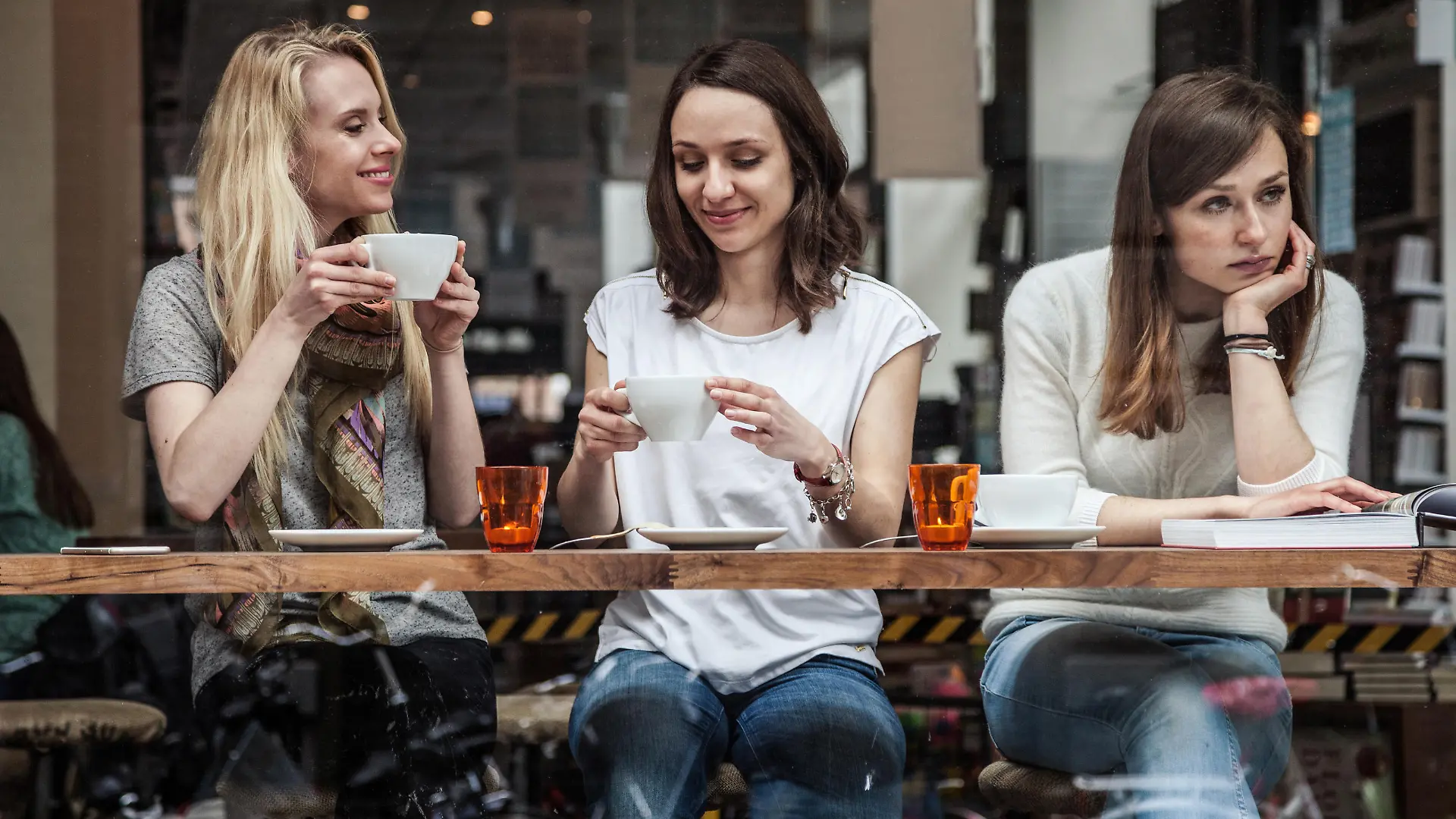 Group of women seated at a cafe's window relaxing during a cold afternoon in Scandinavia, Copenhagen.
