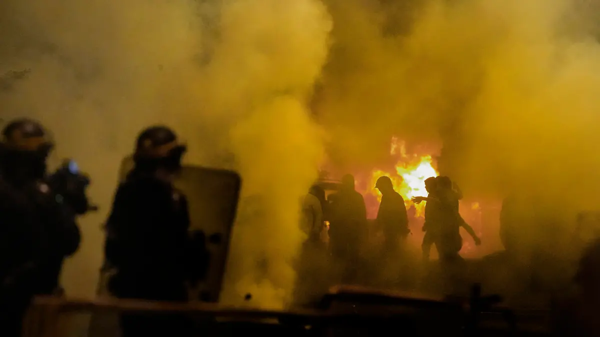 Police forces clash with youths in Nanterre, outside Paris, Thursday, June 29, 2023. French President Emmanuel Macron has described the killing of a 17-year-old delivery driver by police at a traffic check "inexcusable," and called for a thorough investigation. The death in the Paris suburb of Nanterre prompted scattered violence overnight. (AP Photo/Christophe Ena)