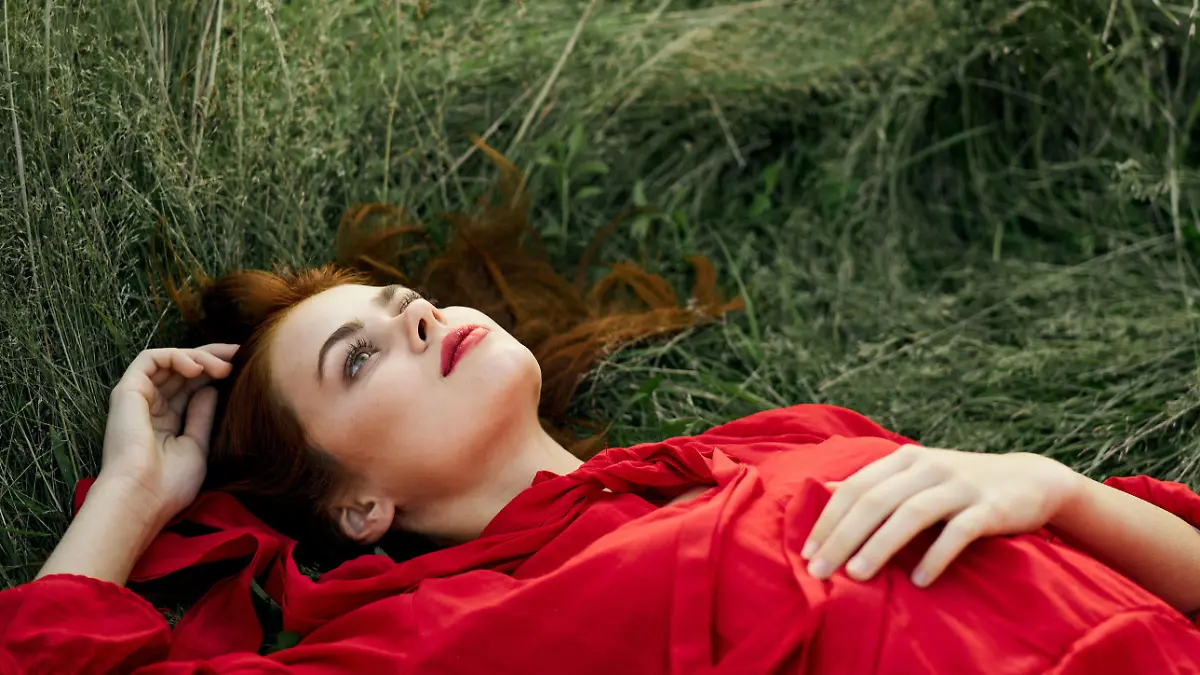 pretty woman in red dress lies on the grass freedom landscape pretty woman in red dress lies on the grass freedom landscape. High quality photo Copyright: xx 43186406
