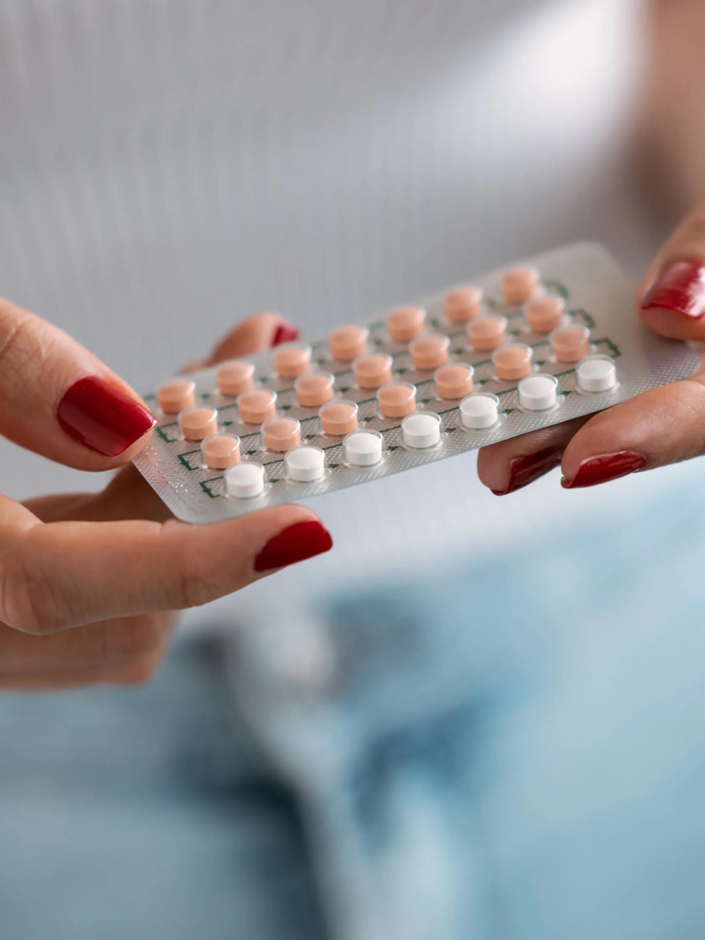 Close-up of woman holding a contraceptive pills. Concept of contraception methods.