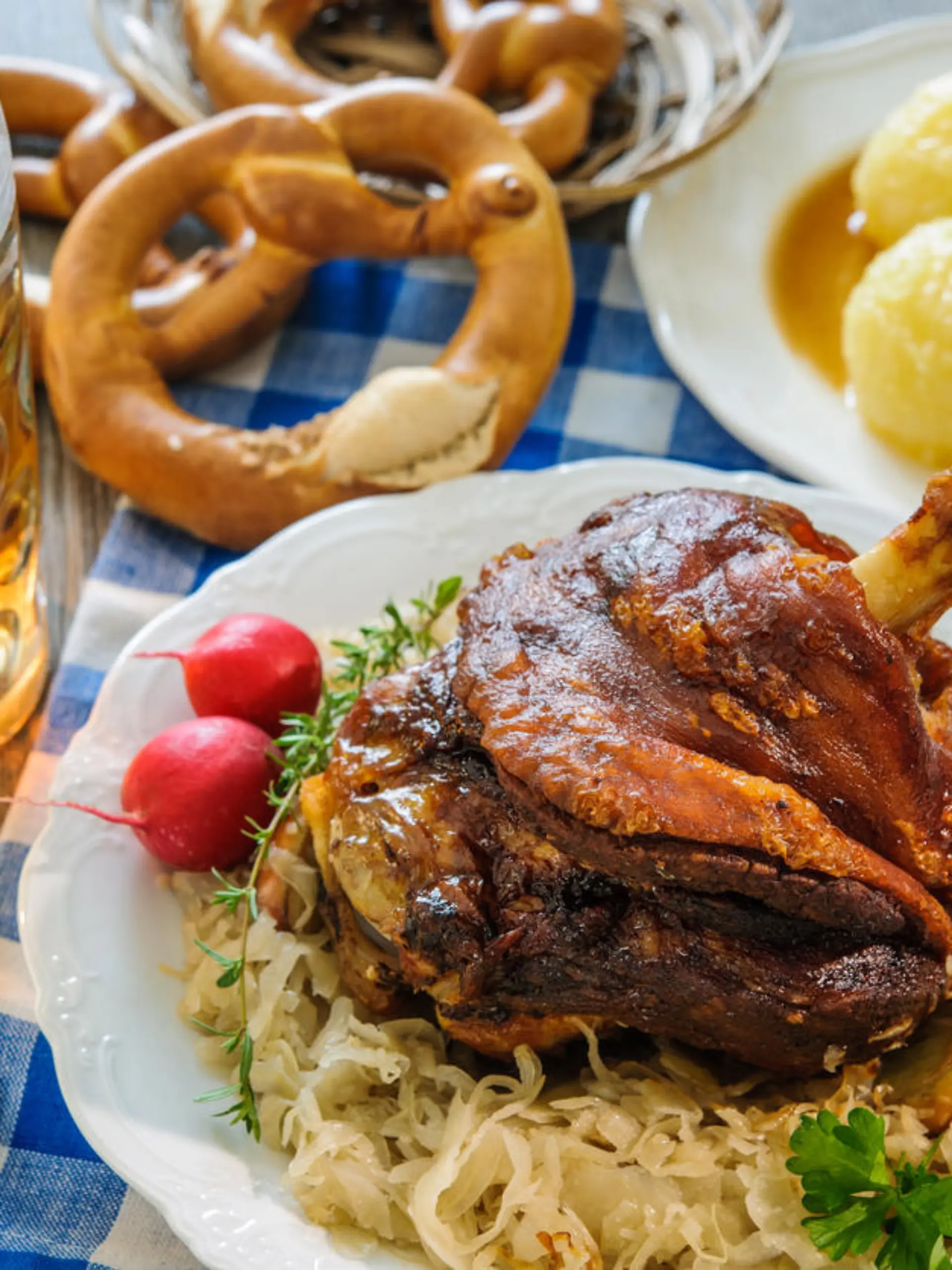 Appetizing Bavarian roast pork knuckle with dumplings and sauerkraut. Oktoberfest