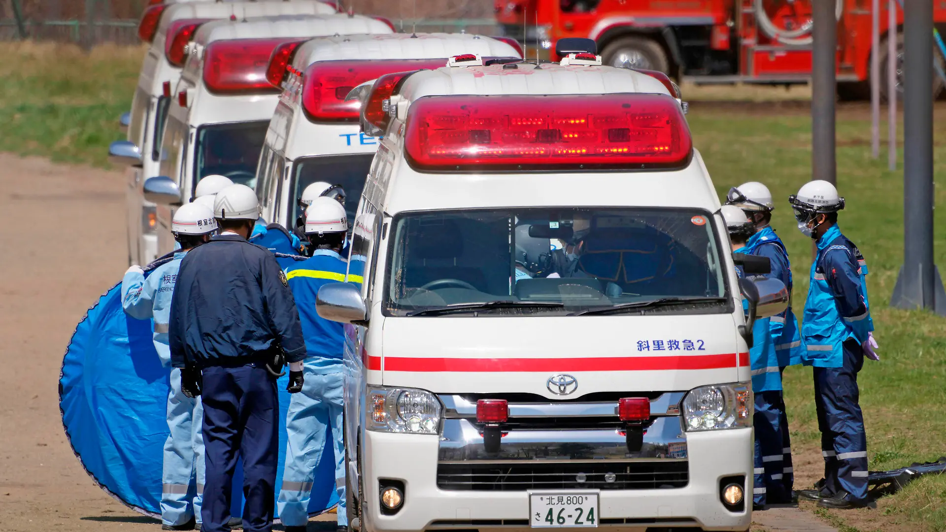 ADDS STORY UPDATE- Emergency personnel transfer a person retrieved from the tour boat accident, in Shari, in the northern island of Hokkaido Sunday, April 24, 2022. The tour boat with 26 aboard sank in rough waters Saturday. Ten people are confirmed to have died and the search continues for the other 16. (Koki Sengoku/Kyodo News via AP)