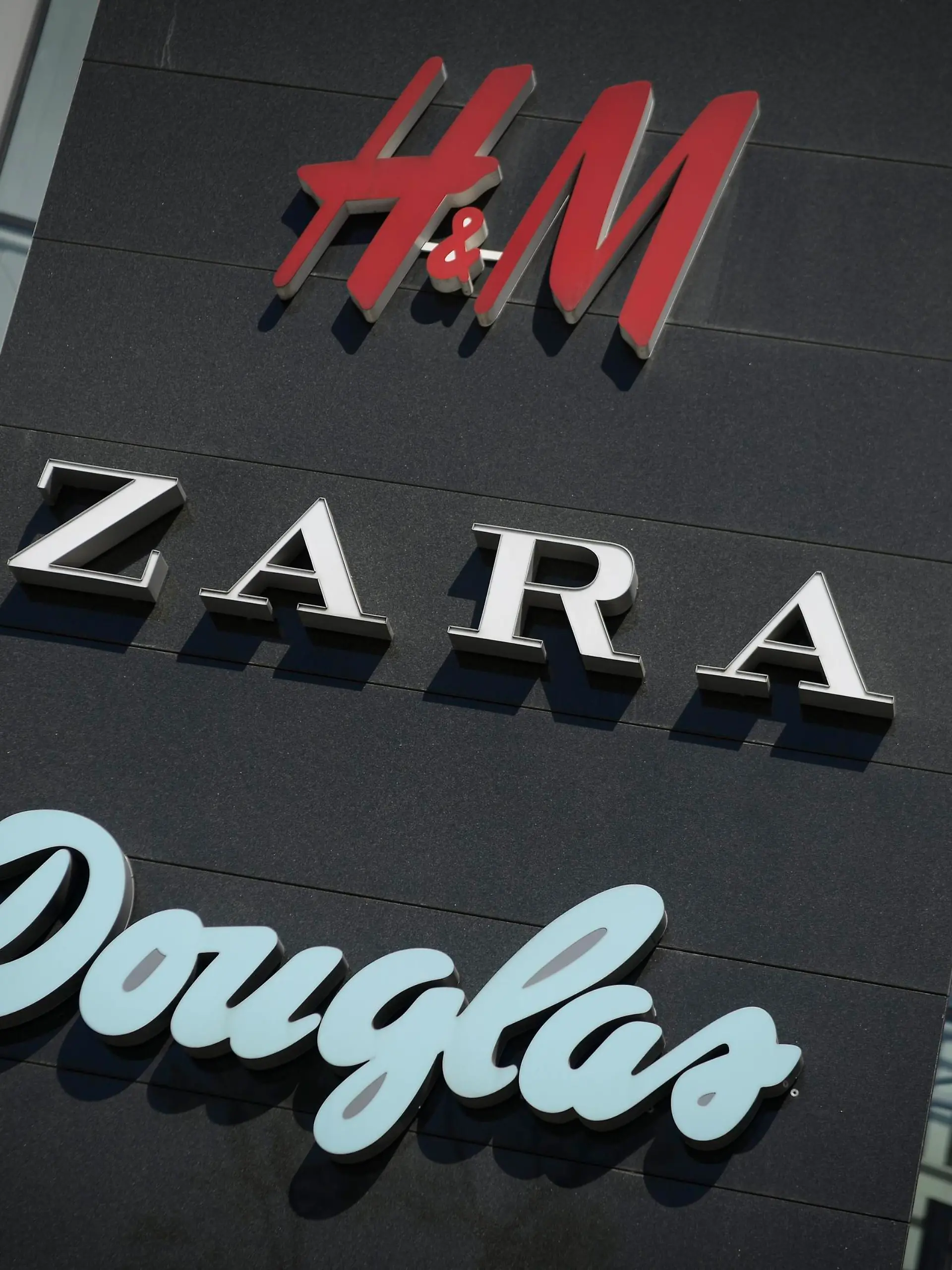 Shop logos are seen at the entrance of the Plac Unii shopping center in Warsaw, Poland on April 22, 2018. (Photo by Jaap Arriens/NurPhoto)