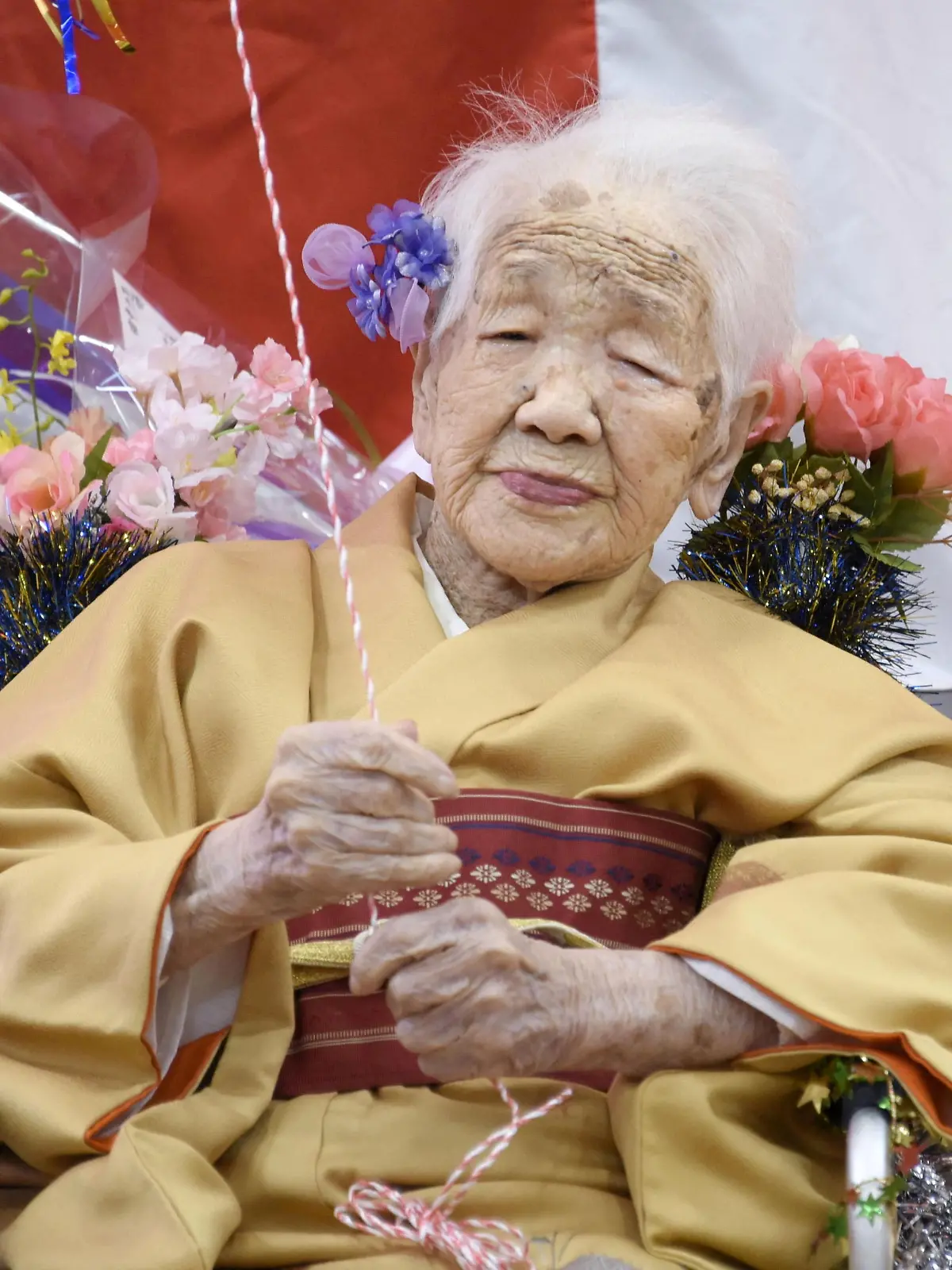 FILE PHOTO: Kane Tanaka, born in 1903, smiles as a nursing home celebrates three days after her 117th birthday in Fukuoka, Japan, in this photo taken by Kyodo January 5, 2020. Mandatory credit Kyodo/via REUTERS ATTENTION EDITORS - THIS IMAGE WAS PROVIDED BY A THIRD PARTY. MANDATORY CREDIT. JAPAN OUT. NO COMMERCIAL OR EDITORIAL SALES IN JAPAN/File Photo