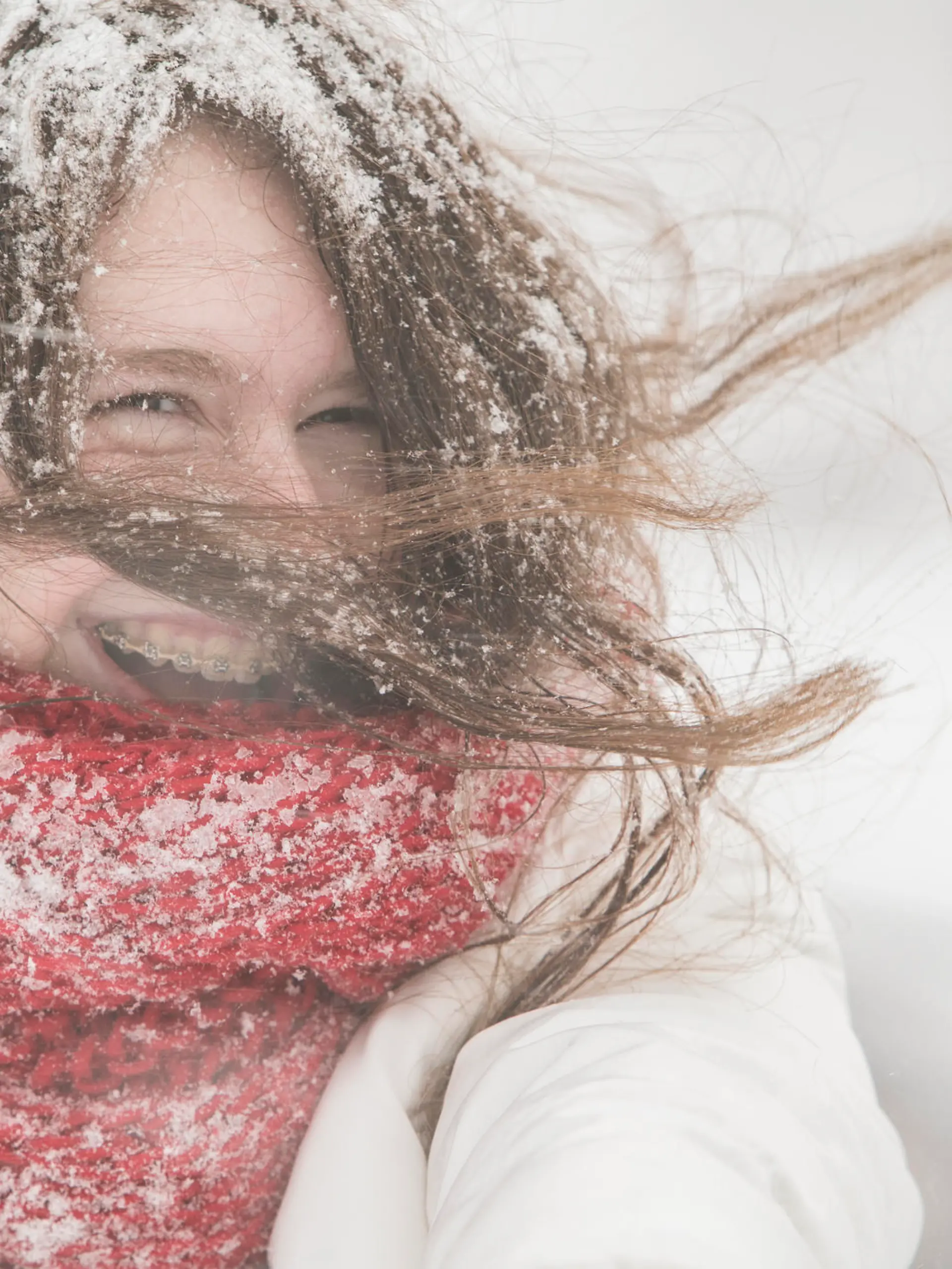 Teenager girl in the blue jacket and cape under snowfall at the street in Queens Village, New York City, NY, during the snowstorm Jonas