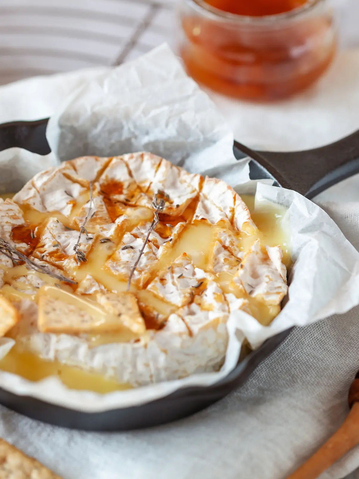 Camembert, französischer Weichkäse mit Honig und Thymian im Ofen gebacken, Seitenansicht