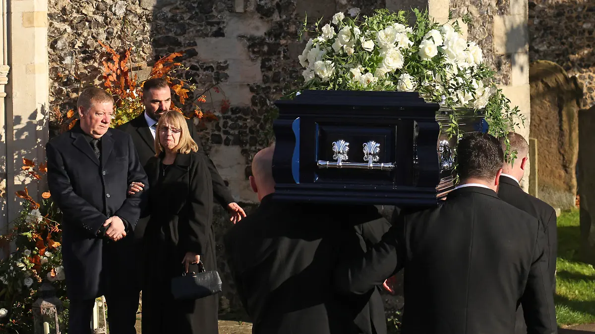 AMERSHAM, ENGLAND - NOVEMBER 20:  The parents of Liam Payne, Karen and Geoff Payne, watch as his coffin is carried into the funeral, on November 20, 2024 in Amersham, United Kingdom. Former One Direction star Liam Payne’s private funeral in Amersham has been widely anticipated to draw celebrities and fans alike, wishing to pay their final respects. The singer died after falling from a hotel balcony in Buenos Aires on October 16. 