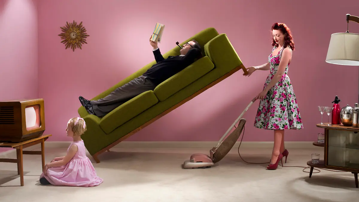 1950s glamorous housewife cracks on with the cleaning