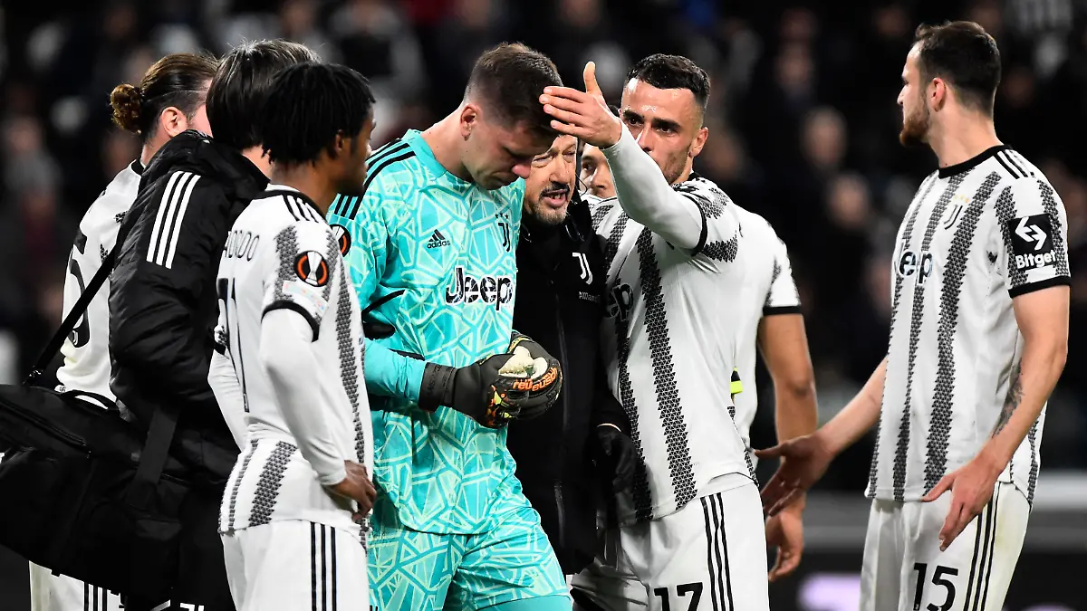 Soccer Football - Europa League - Quarter Final - First Leg - Juventus v Sporting CP - Allianz Stadium, Turin, Italy - April 13, 2023 Juventus' Wojciech Szczesny is patted on the head by Filip Kostic as he substituted off after sustaining an injury REUTERS/Massimo Pinca