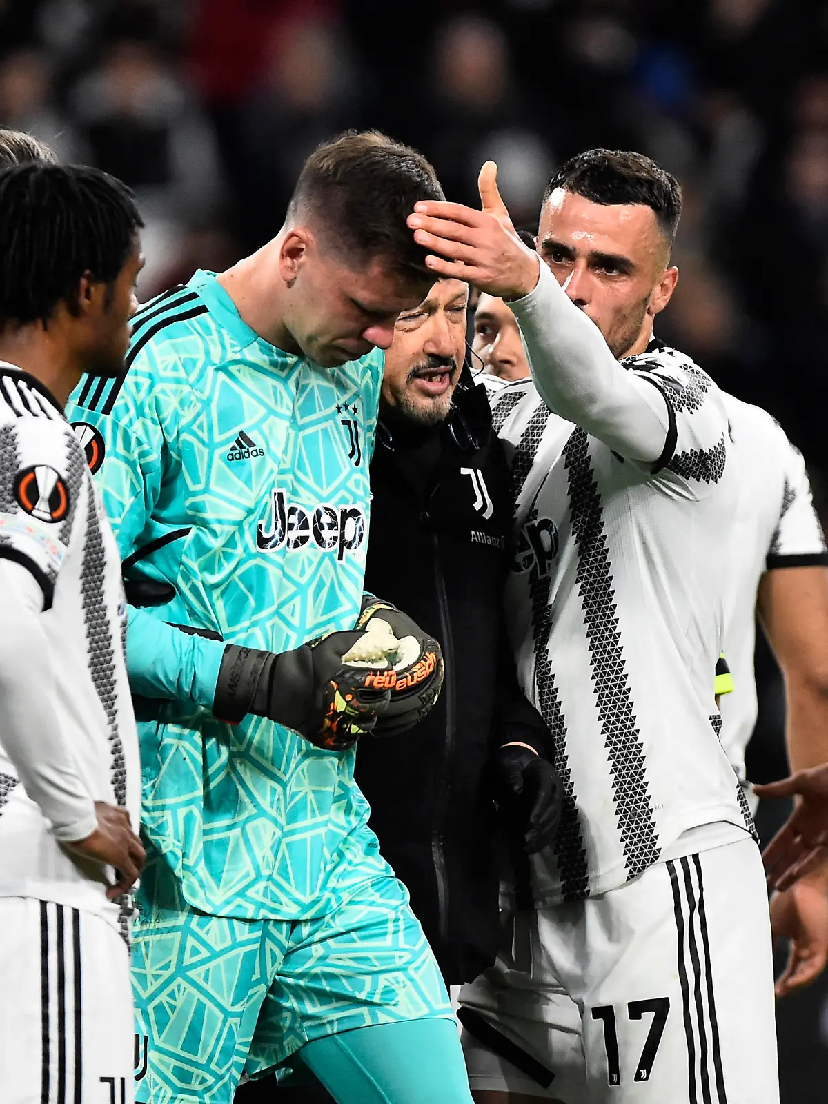 Soccer Football - Europa League - Quarter Final - First Leg - Juventus v Sporting CP - Allianz Stadium, Turin, Italy - April 13, 2023 Juventus' Wojciech Szczesny is patted on the head by Filip Kostic as he substituted off after sustaining an injury REUTERS/Massimo Pinca