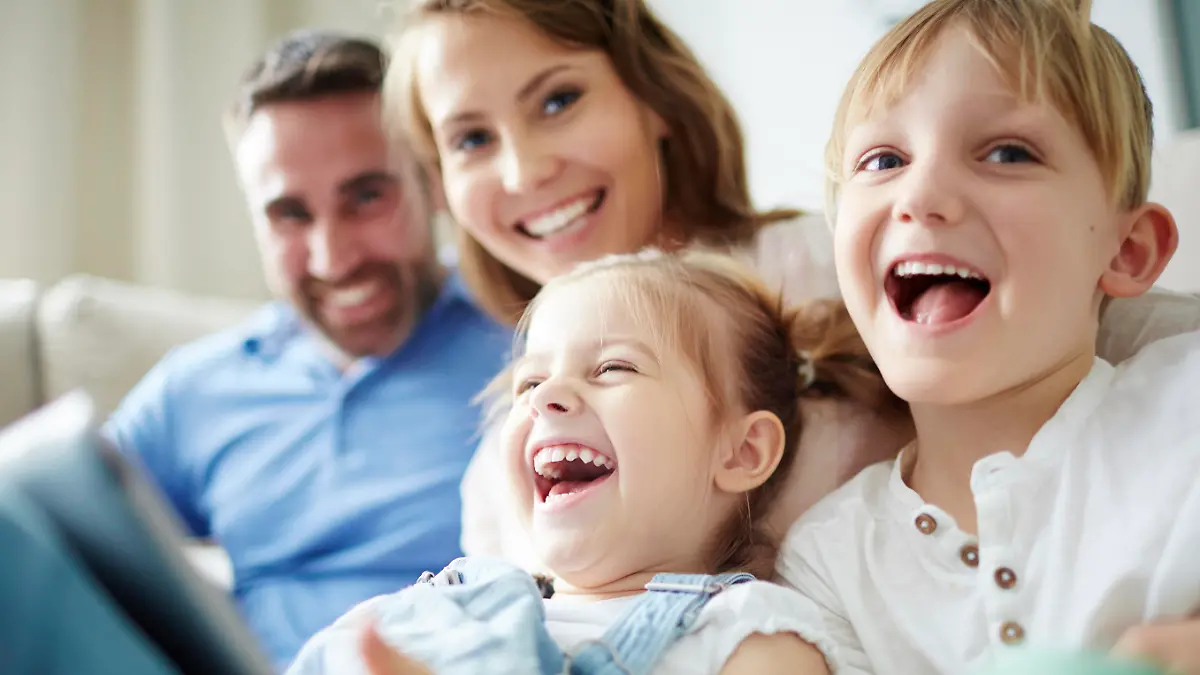 Children sitting together with parents and laughing