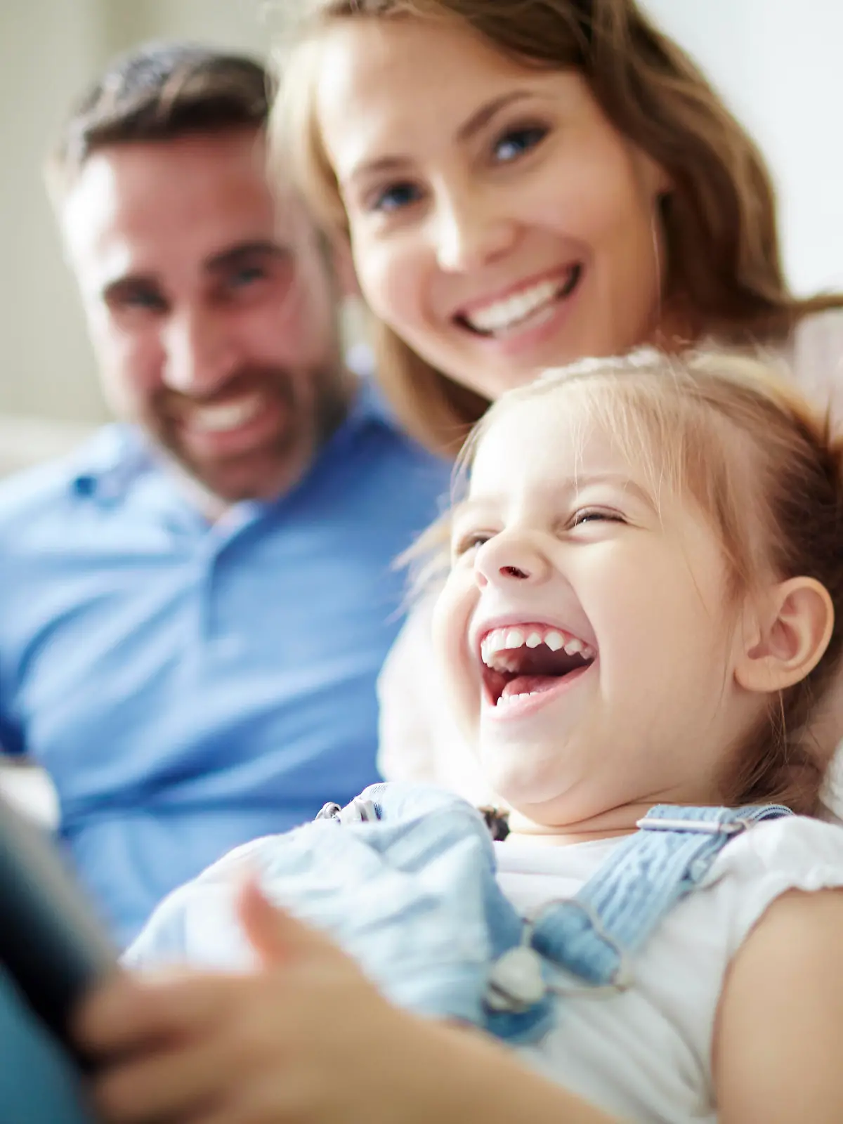 Children sitting together with parents and laughing