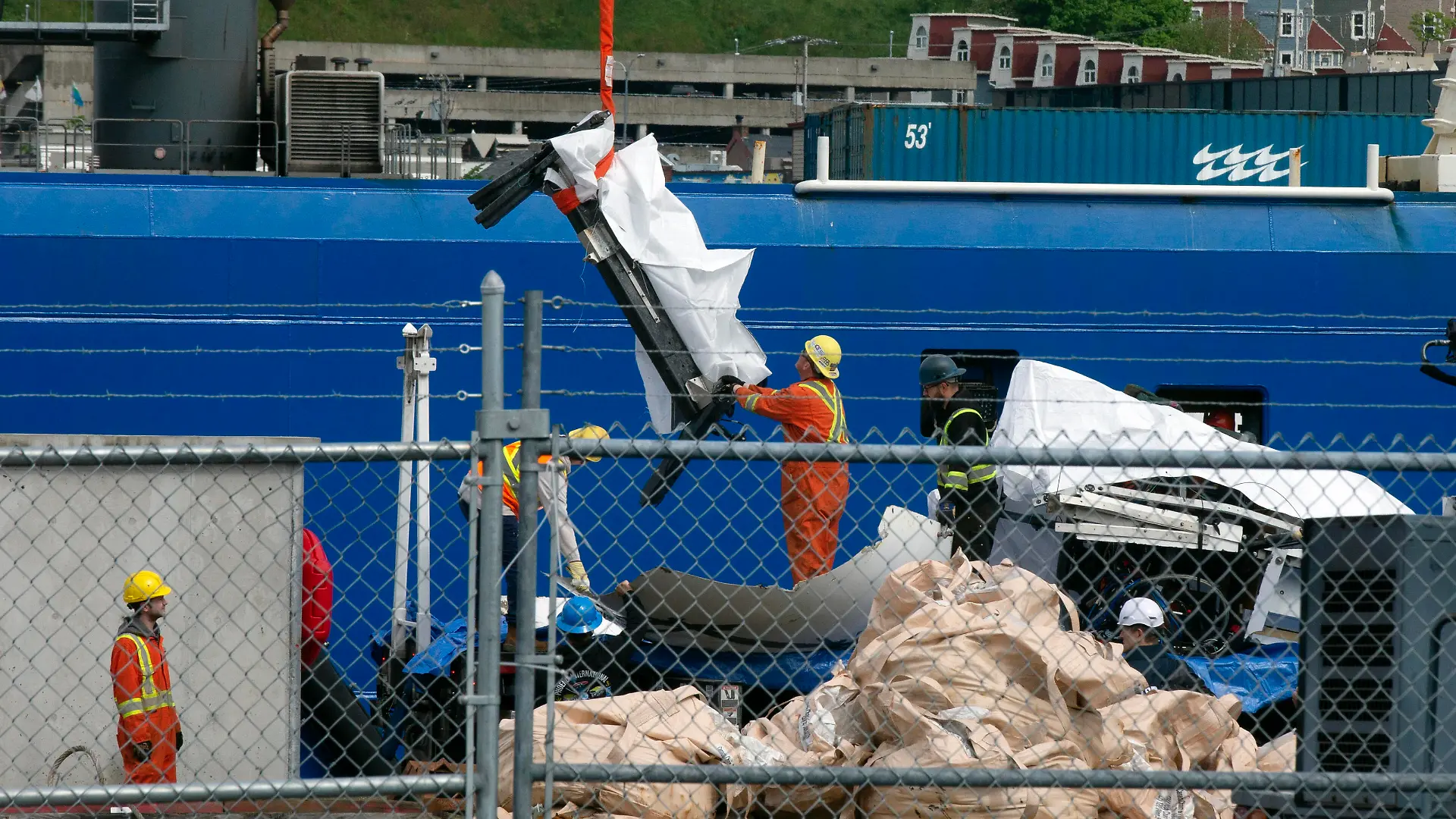 Debris from the Titan submersible, recovered from the ocean floor near the wreck of the Titanic, is unloaded from the ship Horizon Arctic at the Canadian Coast Guard pier in St. John's, Newfoundland, Wednesday, June 28, 2023. (Paul Daly/The Canadian Press via AP)