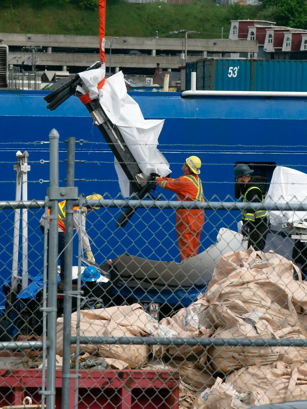 Debris from the Titan submersible, recovered from the ocean floor near the wreck of the Titanic, is unloaded from the ship Horizon Arctic at the Canadian Coast Guard pier in St. John's, Newfoundland, Wednesday, June 28, 2023. (Paul Daly/The Canadian Press via AP)