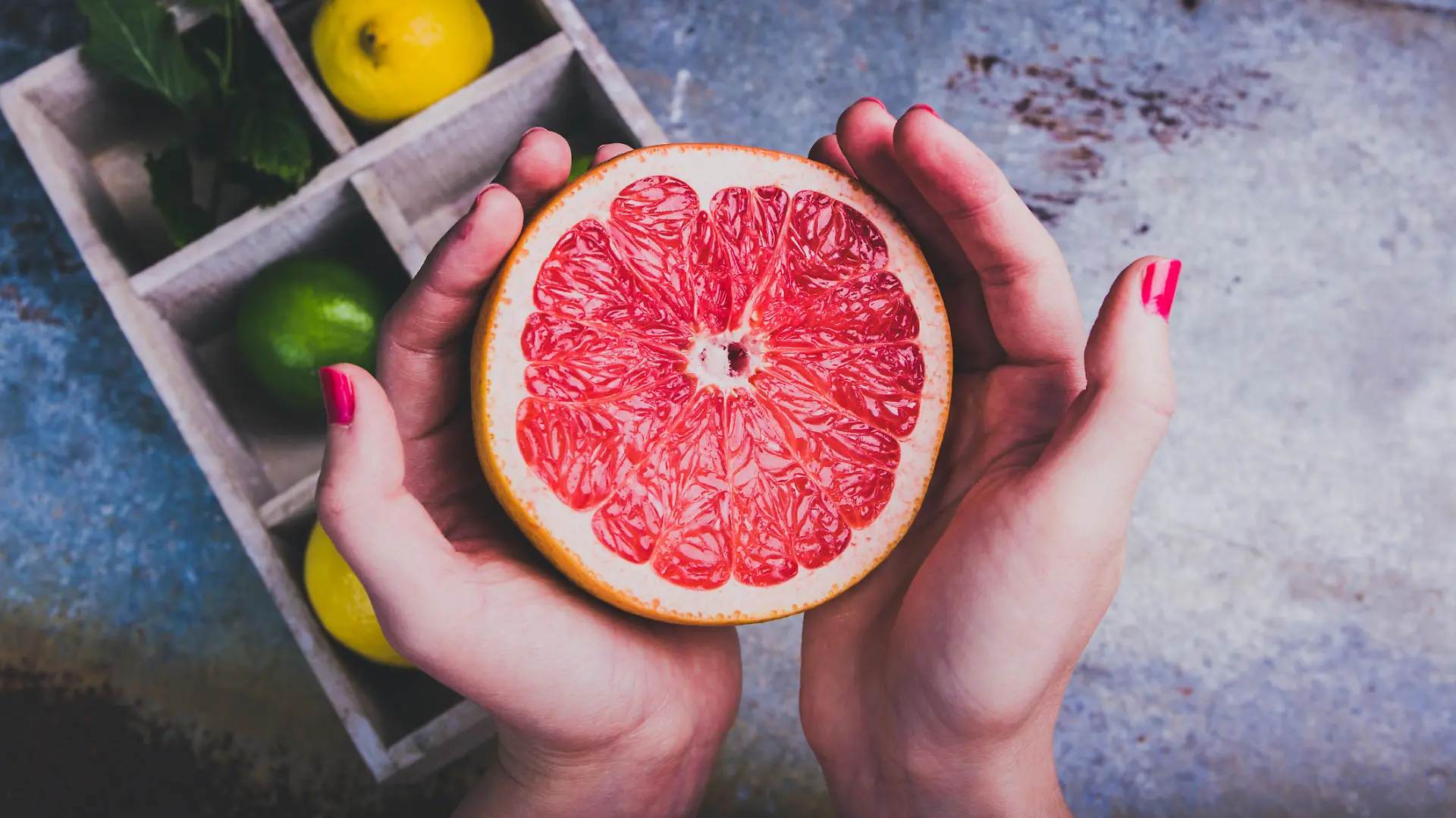 Woman holding a grapefruit