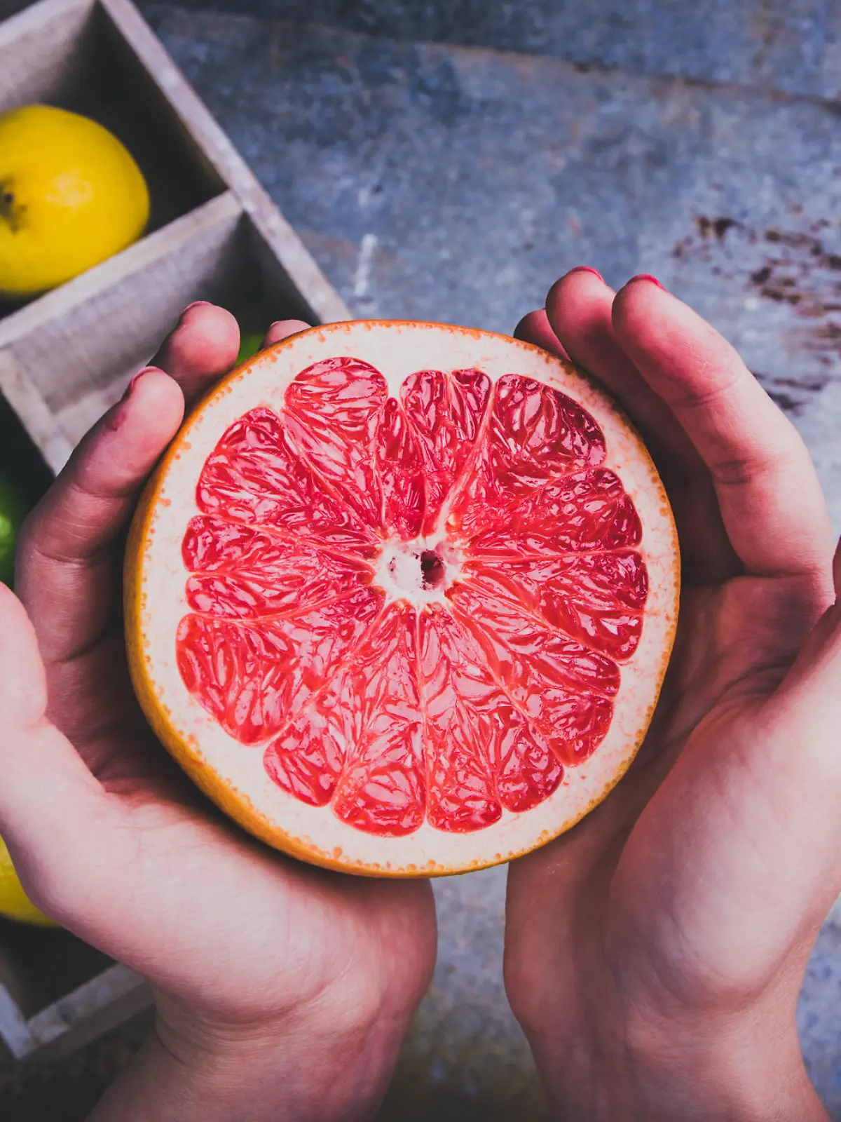 Woman holding a grapefruit