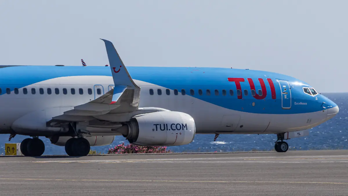 TUIfly Boeing 737-800 passenger aircraft as seen on the taxiway with the Aegean Sea in the background after landing at Heraklion International Airport Nikos Kazantzakis in Crete Island, Greece. 