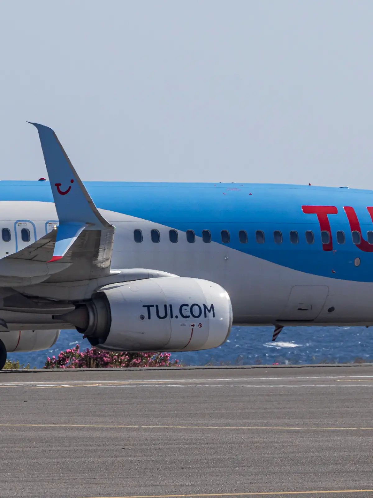 TUIfly Boeing 737-800 passenger aircraft as seen on the taxiway with the Aegean Sea in the background after landing at Heraklion International Airport Nikos Kazantzakis in Crete Island, Greece. 