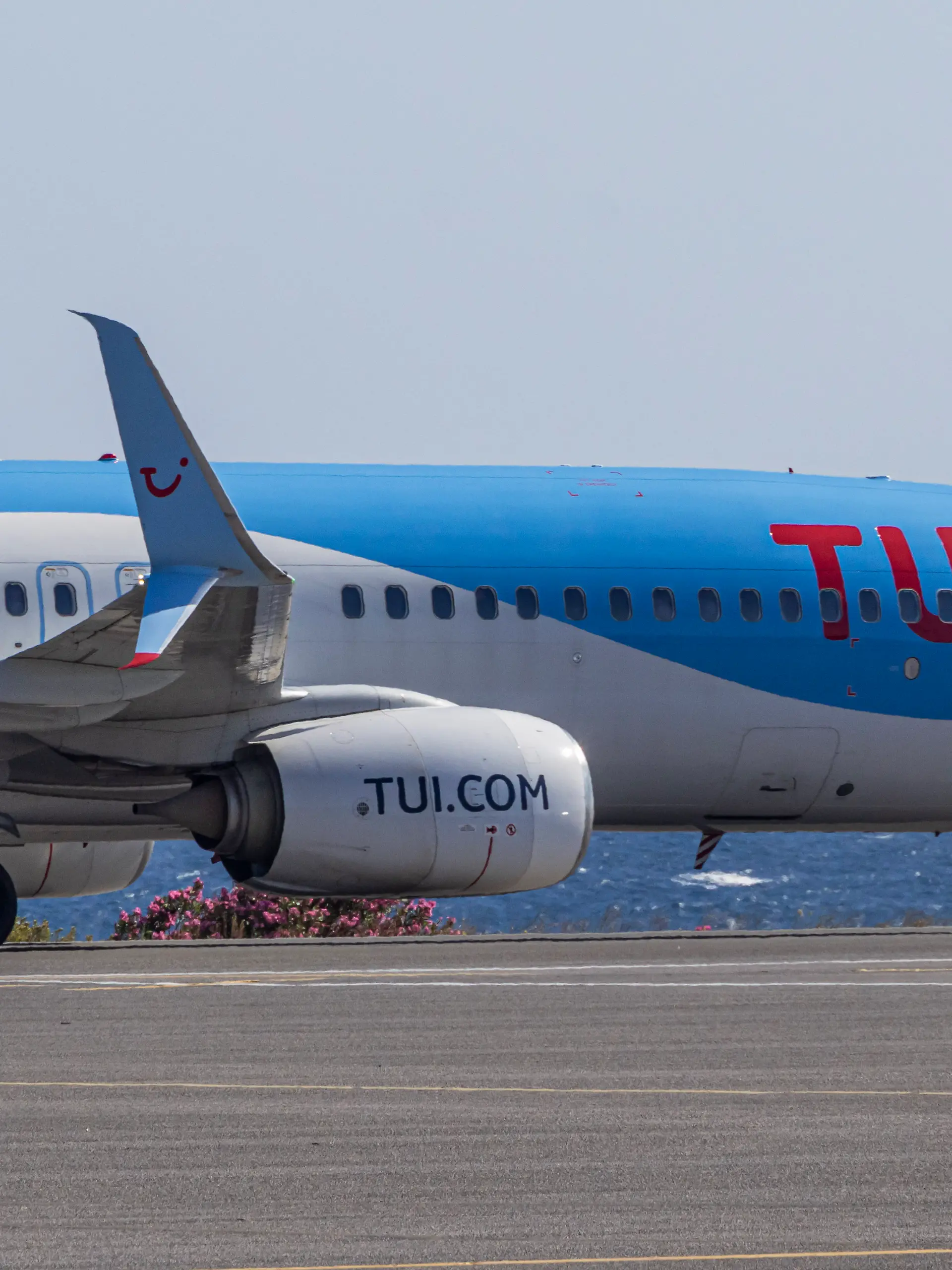 TUIfly Boeing 737-800 passenger aircraft as seen on the taxiway with the Aegean Sea in the background after landing at Heraklion International Airport Nikos Kazantzakis in Crete Island, Greece. 