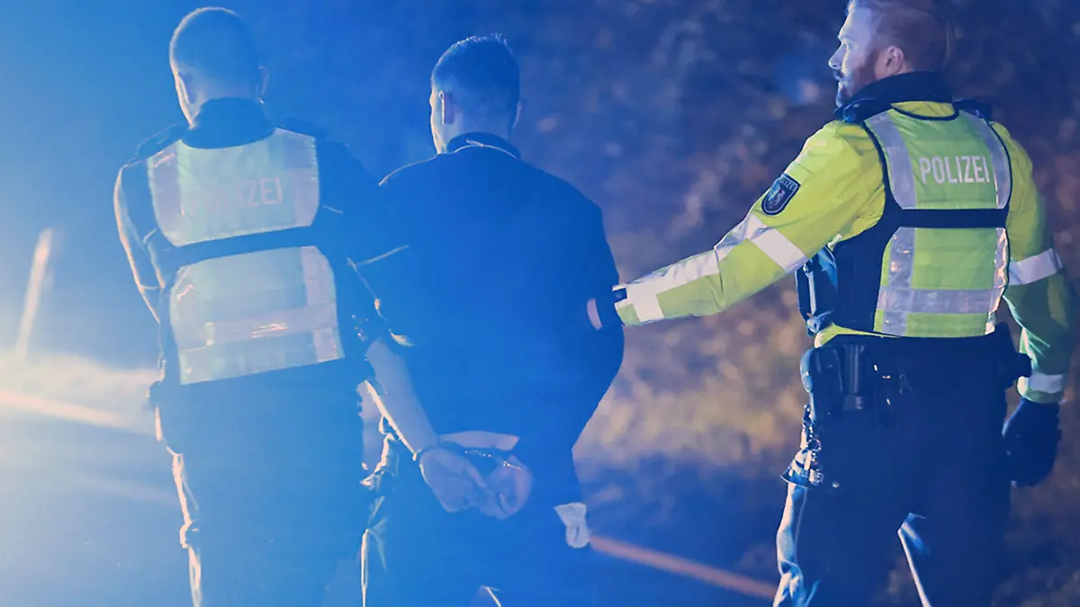 30.11.2024, Nordrhein-Westfalen, Hagen: Polizisten nehmen einen Lastwagenfahrer (M) auf der Autobahn 1 bei Hagen in Gewahrsam. Bei der Chaosfahrt eines Lastwagens über mehrere Autobahnen in Nordrhein-Westfalen sind mehrere Menschen schwer verletzt worden, wie die Polizei mitteilte. Foto: Alex Talash/dpa +++ dpa-Bildfunk +++