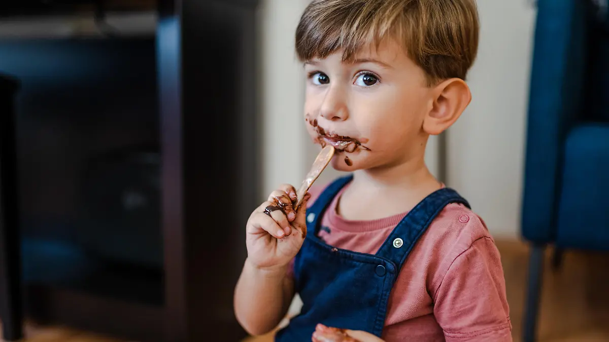 Cute little boy enjoy eating ice cream at home