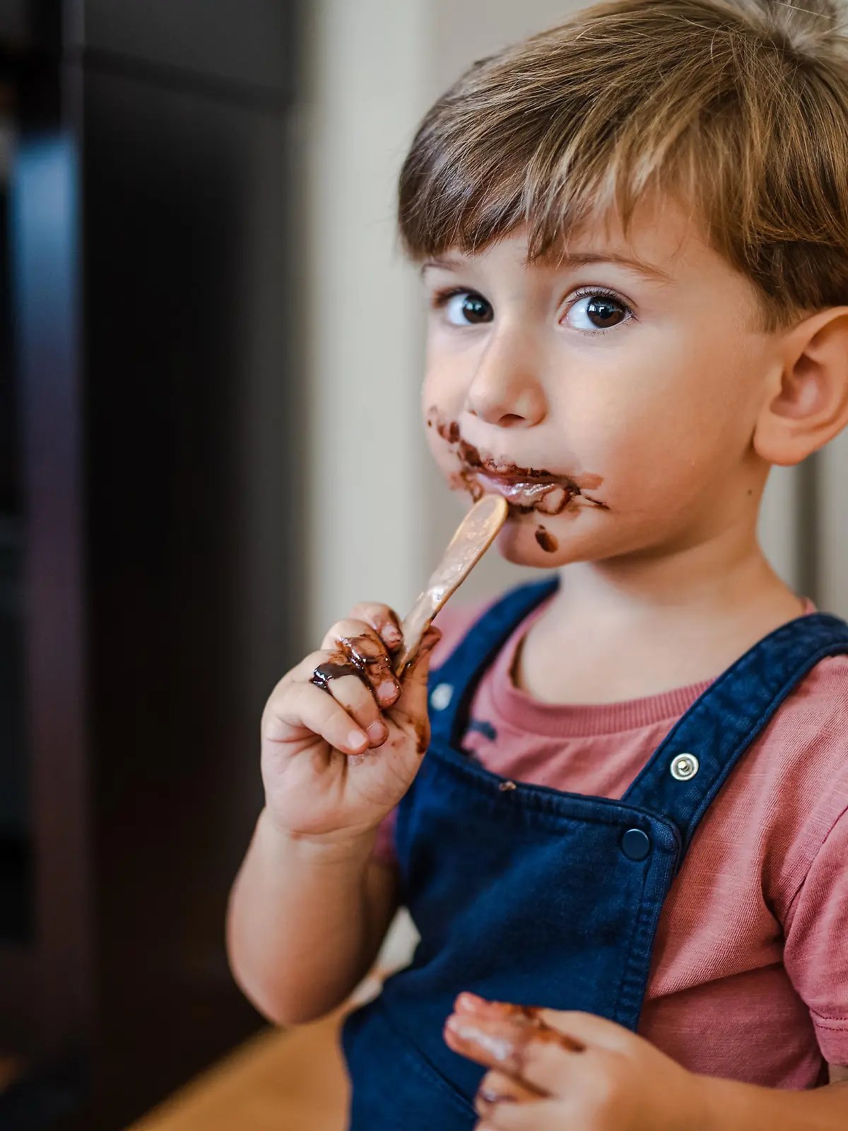 Cute little boy enjoy eating ice cream at home