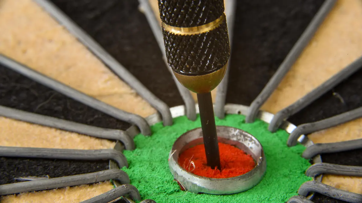 Den Helder, Netherlands. August 2022. Close up of a dart in the bullseye ye of the dartboard. High quality photo