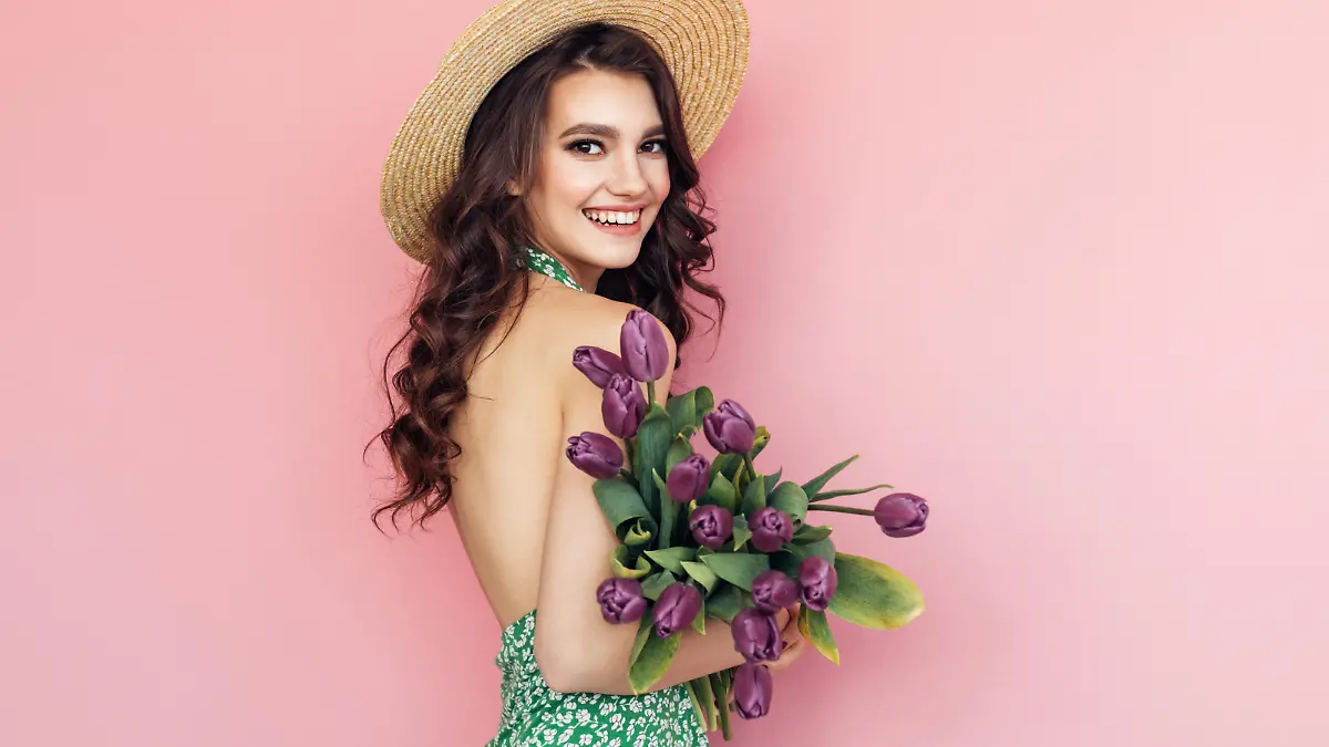 Lovely woman with purple tulips bunch