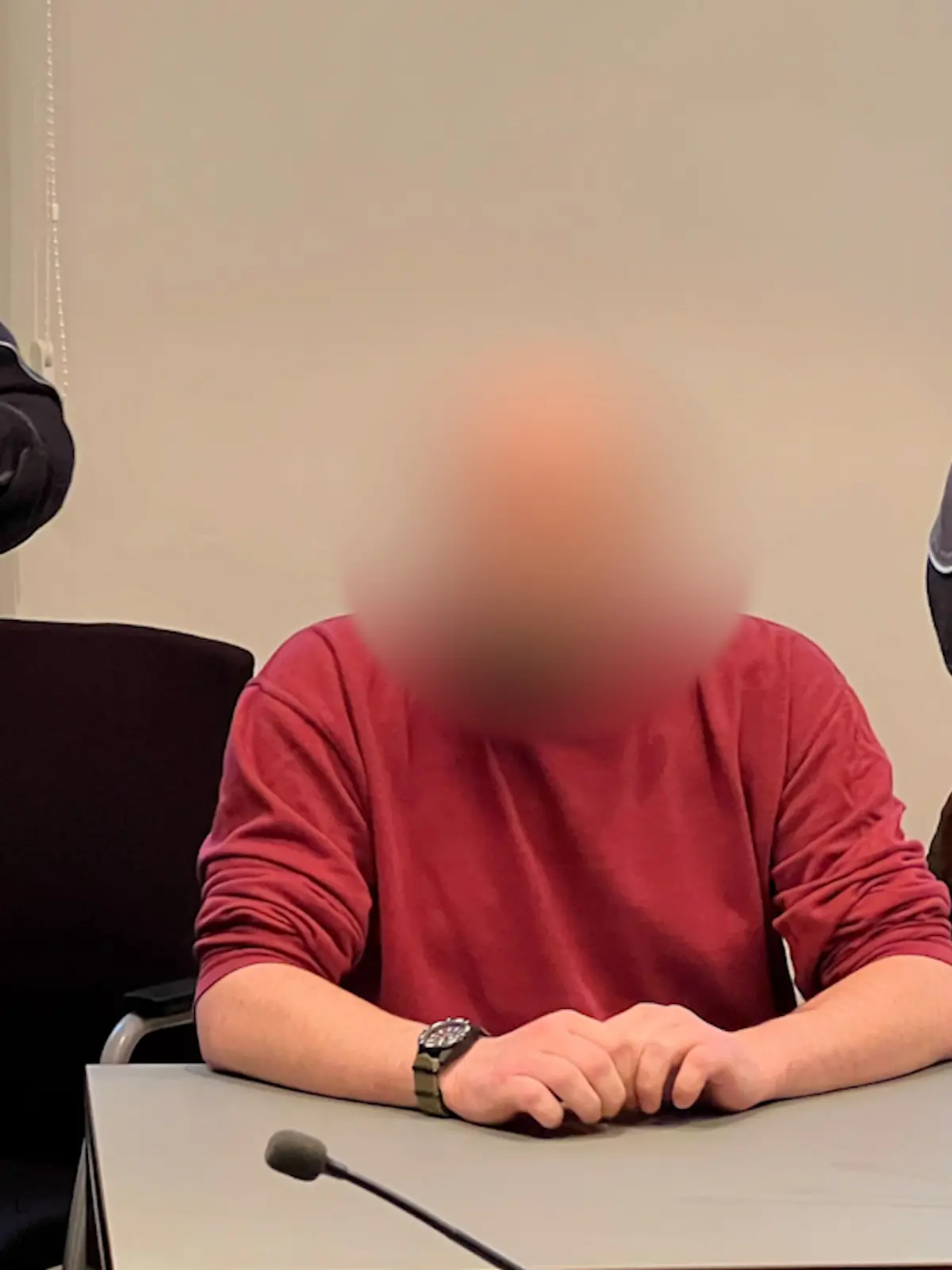 Mit Handschellen, Fußfesseln und vier Justizbeamten wird der Mann in den Gerichtsaal geführt. 