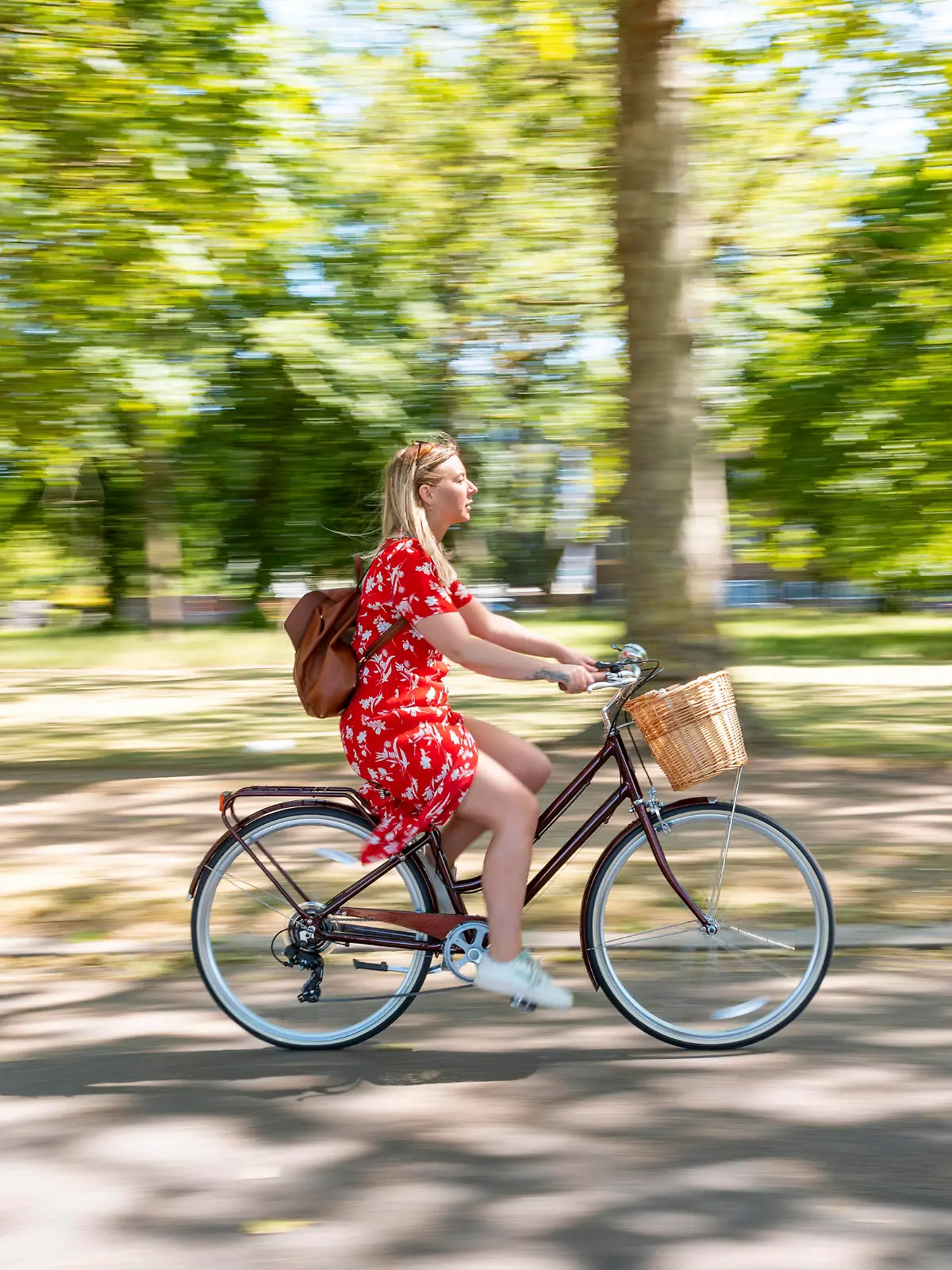 Blurred motion of woman riding bicycle on footpath at public park model released Symbolfoto PUBLICATIONxINxGERxSUIxAUTxHUNxONLY WPEF03064
