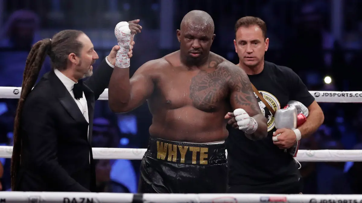 FILE - Dillian Whyte of Britain celebrates winning against Mariusz Wach of Poland fight during a heavyweight undercard boxing match at the Diriyah Arena, in Riyadh, Saudi Arabia, Saturday, Dec. 7, 2019. Whyte’s journey to a long-awaited shot at the world heavyweight title has followed a well-worn path for boxers, from a grim existence on the streets to the salvation of the ring. (AP Photo/Hassan Ammar, File)