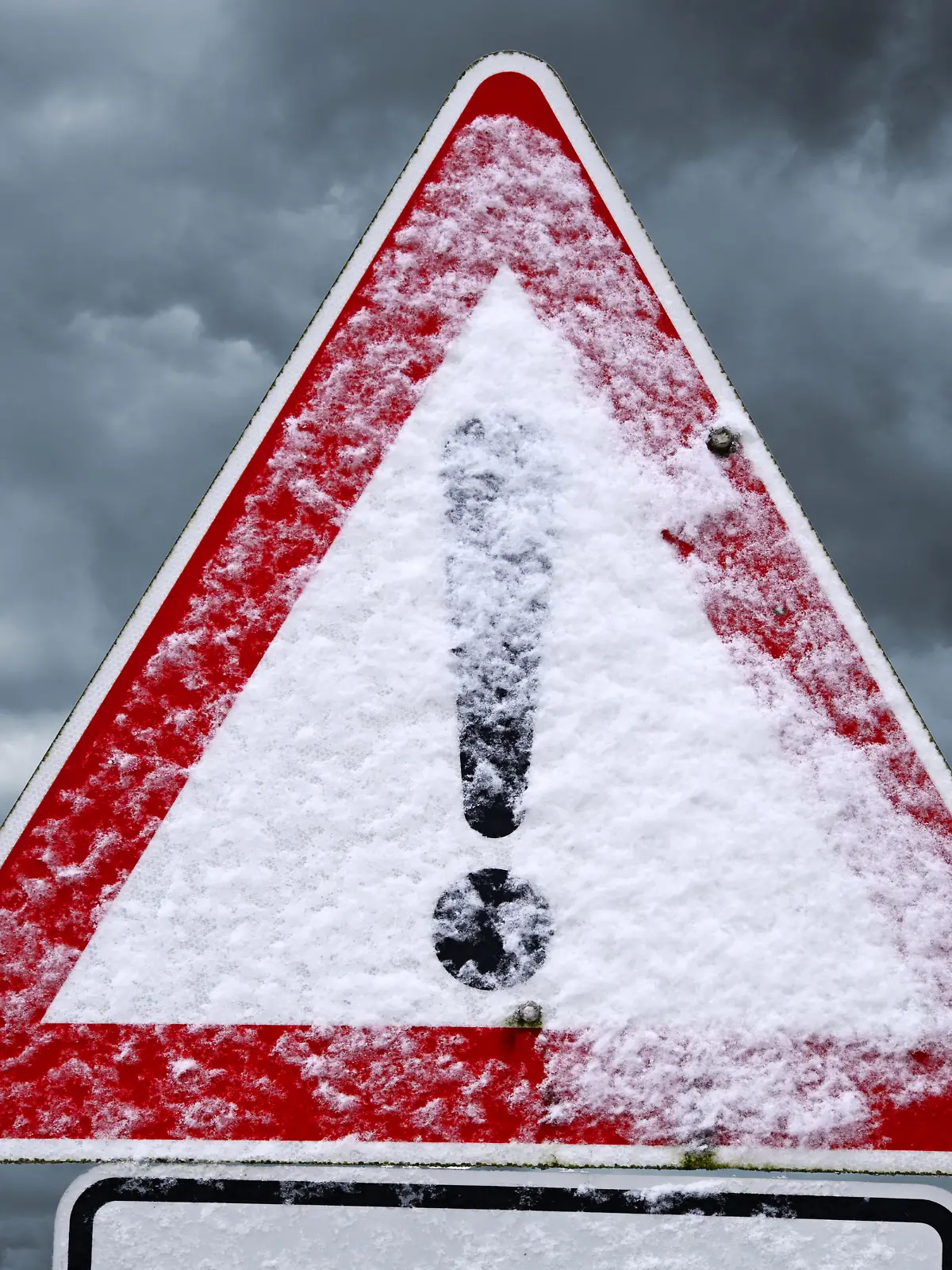 Verschneites Schild mit Ausrufezeichen, Symbolfoto Schneeglätte, Glatteis und winterliche Straßenverhätnisse, Fotomontage