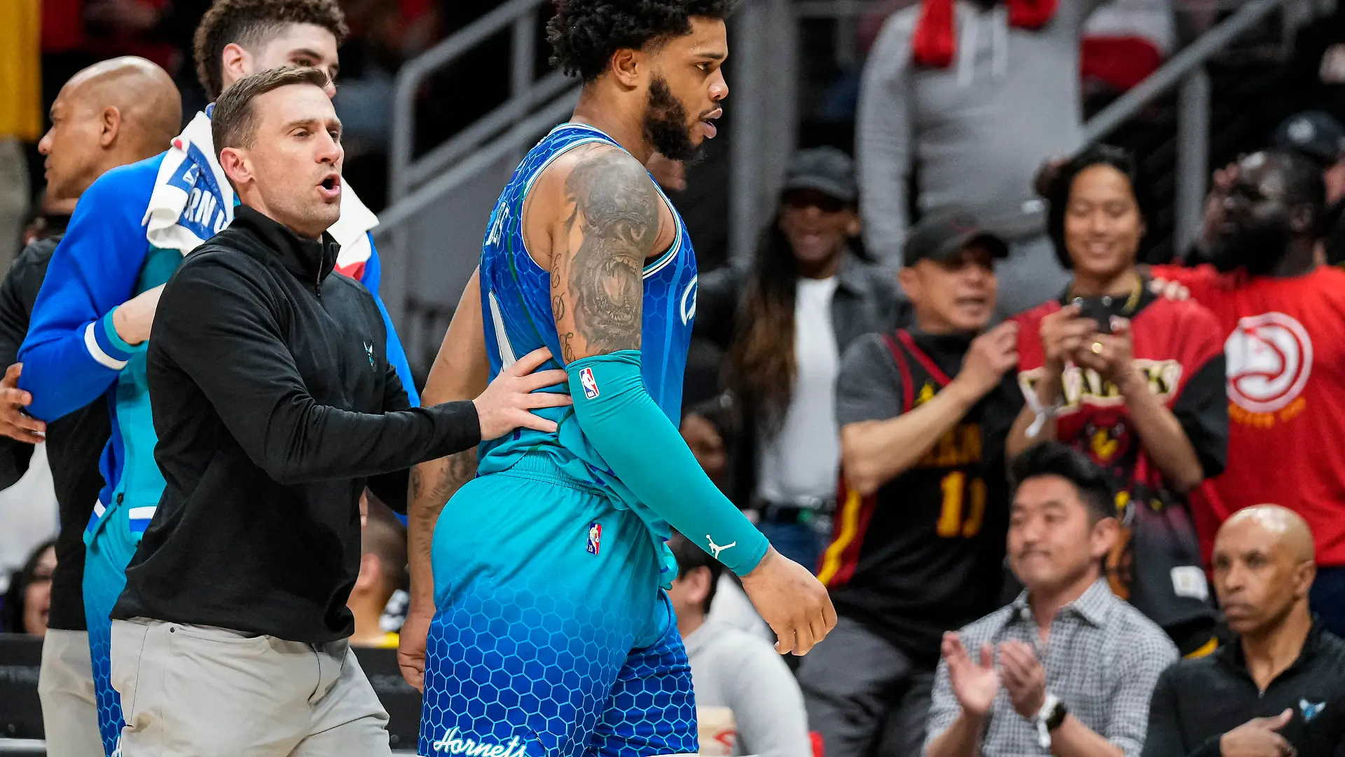 Apr 13, 2022; Atlanta, Georgia, USA; Charlotte Hornets forward Miles Bridges (0) is restrained after being called for a technical foul and being ejected from the game against the Atlanta Hawks during the second half at State Farm Arena. Mandatory Credit: Dale Zanine-USA TODAY Sports