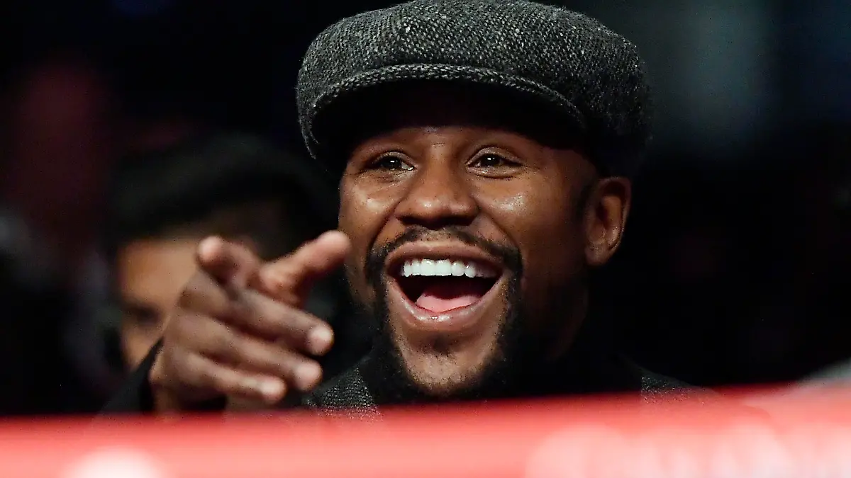 Boxer Floyd Mayweather points to someone in the crowd as he watches a boxing match between Deontay Wilder and Tyson Fury, of England, for the WBC heavyweight championship, Saturday, Dec. 1, 2018, in Los Angeles. (AP Photo/Mark J. Terrill)