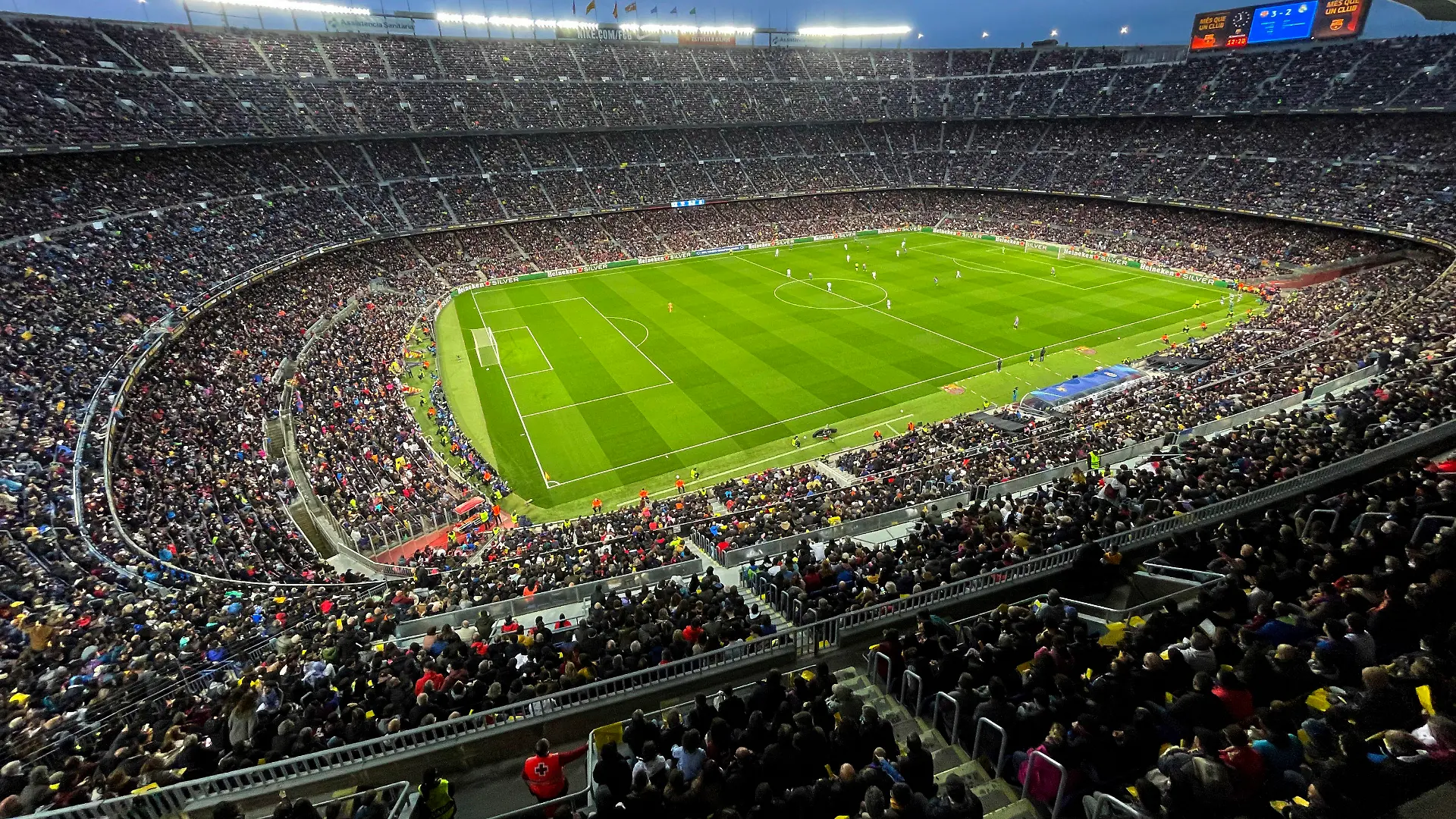 Spectators crowd the Camp Nou stadium during the Women's Champions League quarter final, second leg soccer match between Barcelona and Real Madrid in Barcelona, Spain, Wednesday, March 30, 2022. A world-record crowd for a women's soccer match of more than 91,000 people watched Barcelona defeat Real Madrid 5-2 in the Champions League at the Camp Nou Stadium. (AP Photo/Maria Angela Angles)