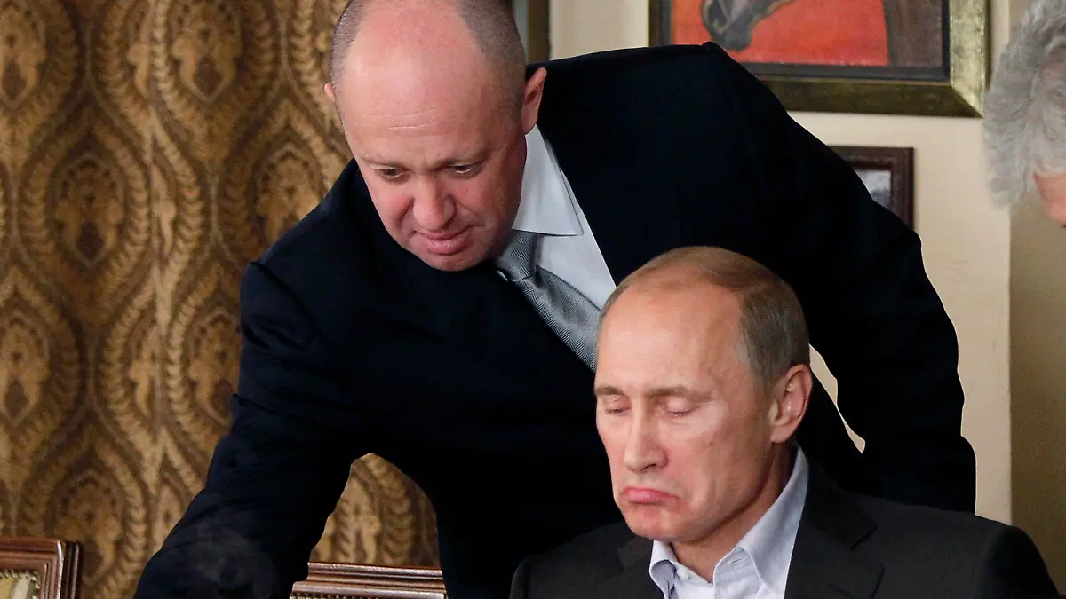 FILE Yevgeny Prigozhin, top, serves food to then-Russian Prime Minister Vladimir Putin at Prigozhin's restaurant outside Moscow, Russia on Nov. 11, 2011. Prigozhin, the owner of the Wagner private military contractor who called for an armed rebellion aimed at ousting Russia's defense minister has confirmed in a video that he and his troops have reached Rostov-on-Don. (AP Photo, File)
