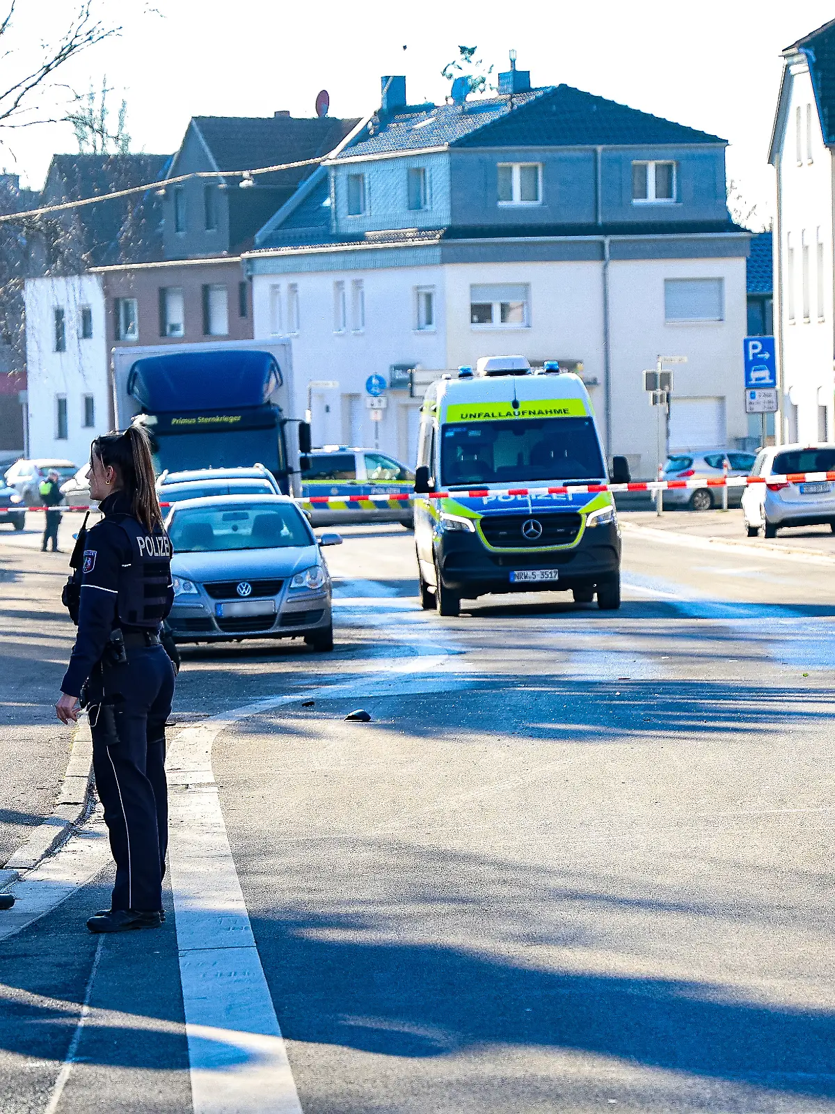 Polizeibeamte stehen an der abgesperrten Unfallstelle. 