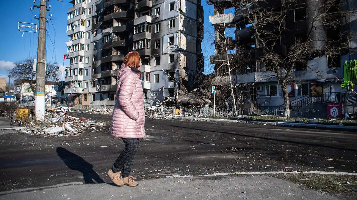 April 8, 2022, Borodyanka, Kyiv Oblast, Ukraine: A woman walks past a building severely damaged by shelling in Borodyanka, a town outside Kyiv that was recently liberated from Russian occupation. (Credit Image: © Laurel Chor/SOPA Images via ZUMA Press Wire