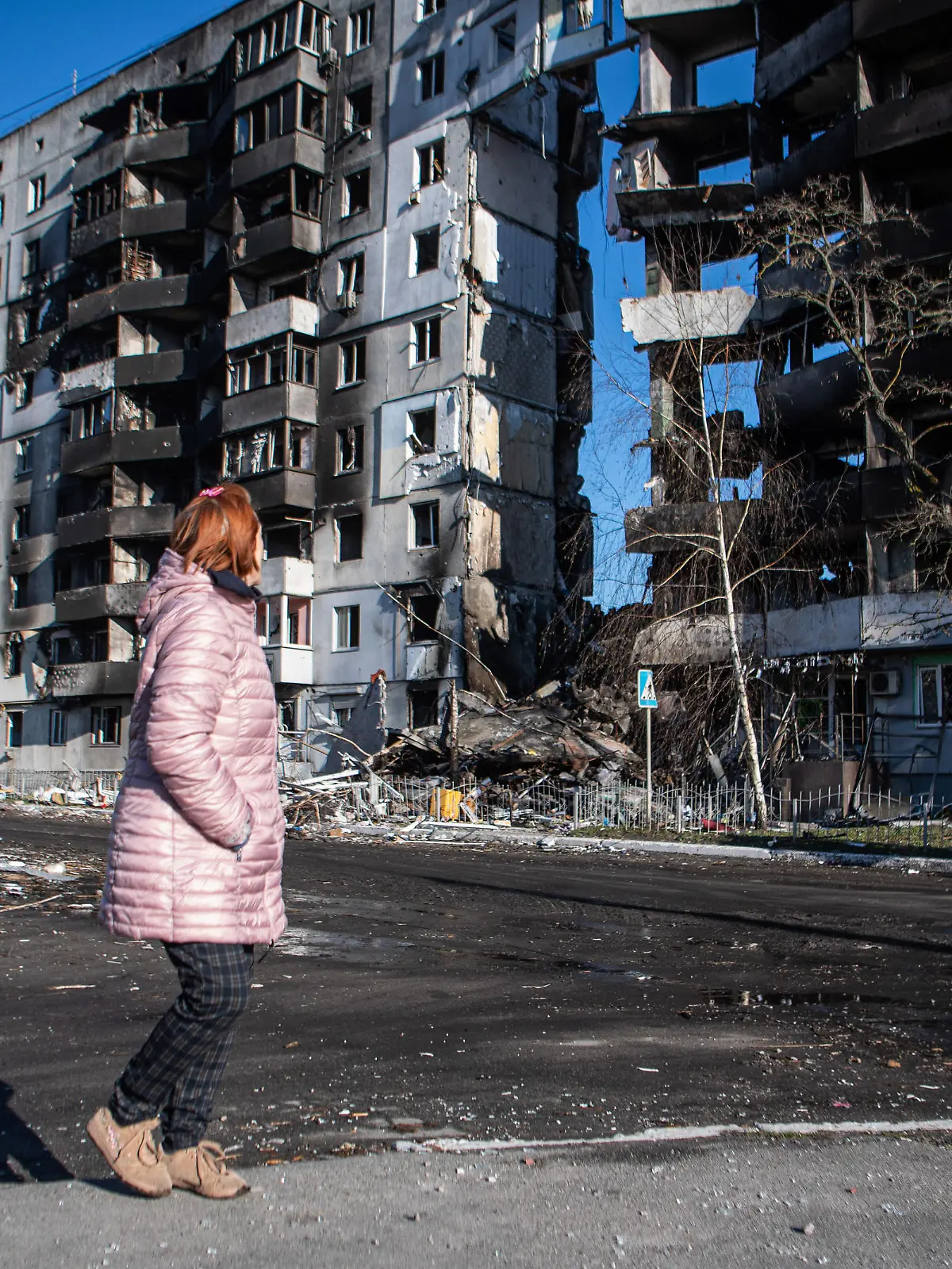 April 8, 2022, Borodyanka, Kyiv Oblast, Ukraine: A woman walks past a building severely damaged by shelling in Borodyanka, a town outside Kyiv that was recently liberated from Russian occupation. (Credit Image: © Laurel Chor/SOPA Images via ZUMA Press Wire