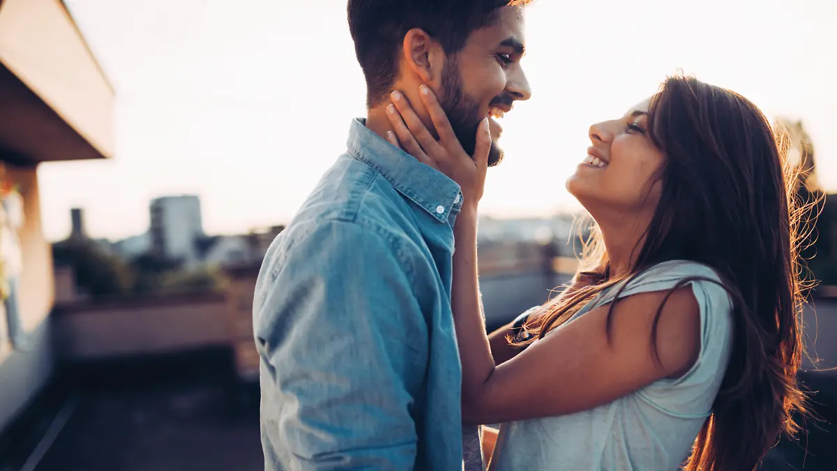 Beautiful young couple in love dating outdoors and smiling