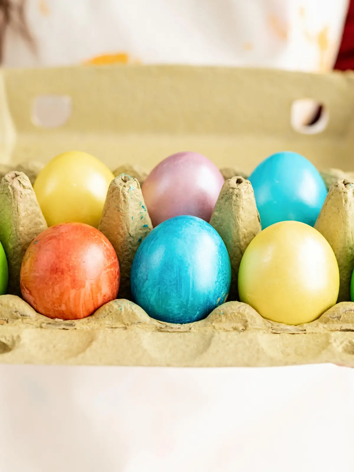 Woman hands holding pack of colorful easter eggs