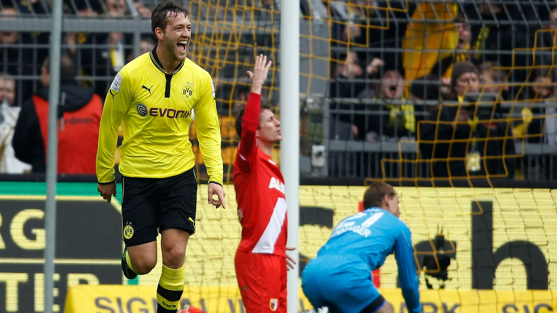 Borussia Dortmund's Julian Schieber (L) celebrates a goal against Augsburg during the German first division Bundesliga soccer match in Dortmund April 6, 2013. REUTERS/Ina Fassbender (GERMANY - Tags: SPORT SOCCER) DFL RULES TO LIMIT THE ONLINE USAGE DURING MATCH TIME TO 15 PICTURES PER GAME. IMAGE SEQUENCES TO SIMULATE VIDEO IS NOT ALLOWED AT ANY TIME. FOR FURTHER QUERIES PLEASE CONTACT DFL DIRECTLY AT + 49 69 650050