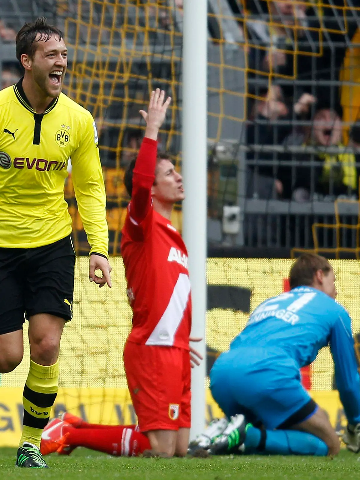 Borussia Dortmund's Julian Schieber (L) celebrates a goal against Augsburg during the German first division Bundesliga soccer match in Dortmund April 6, 2013.  REUTERS/Ina Fassbender (GERMANY - Tags: SPORT SOCCER) DFL RULES TO LIMIT THE ONLINE USAGE DURING MATCH TIME TO 15 PICTURES PER GAME. IMAGE SEQUENCES TO SIMULATE VIDEO IS NOT ALLOWED AT ANY TIME. FOR FURTHER QUERIES PLEASE CONTACT DFL DIRECTLY AT + 49 69 650050
