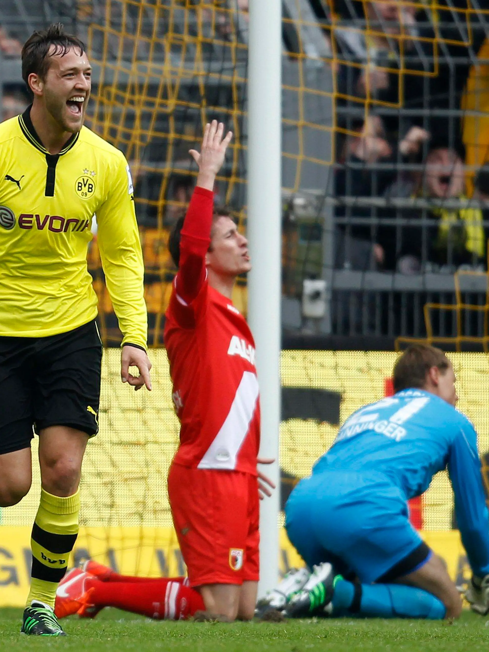 Borussia Dortmund's Julian Schieber (L) celebrates a goal against Augsburg during the German first division Bundesliga soccer match in Dortmund April 6, 2013.  REUTERS/Ina Fassbender (GERMANY - Tags: SPORT SOCCER) DFL RULES TO LIMIT THE ONLINE USAGE DURING MATCH TIME TO 15 PICTURES PER GAME. IMAGE SEQUENCES TO SIMULATE VIDEO IS NOT ALLOWED AT ANY TIME. FOR FURTHER QUERIES PLEASE CONTACT DFL DIRECTLY AT + 49 69 650050