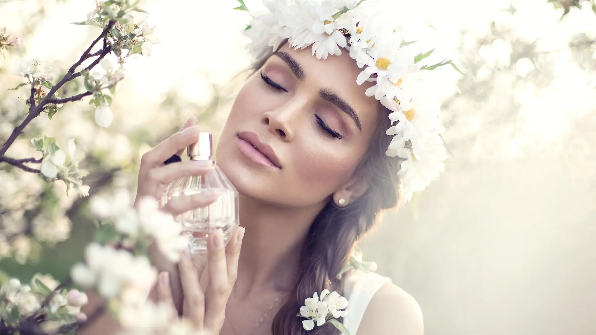 Beautiful sensual woman applying perfume
