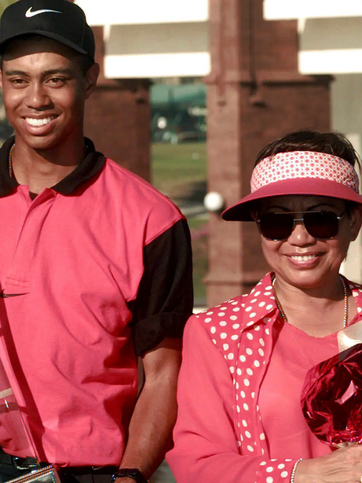 FILE - Golf sensation Tiger Woods, left, poses with his mother Kultida while holding his trophy and key to a new car after winning the Asian Honda Classic in Bangkok, Thailand, Sunday, Feb. 9, 1997. (AP Photo/Charles Dharapak, File)